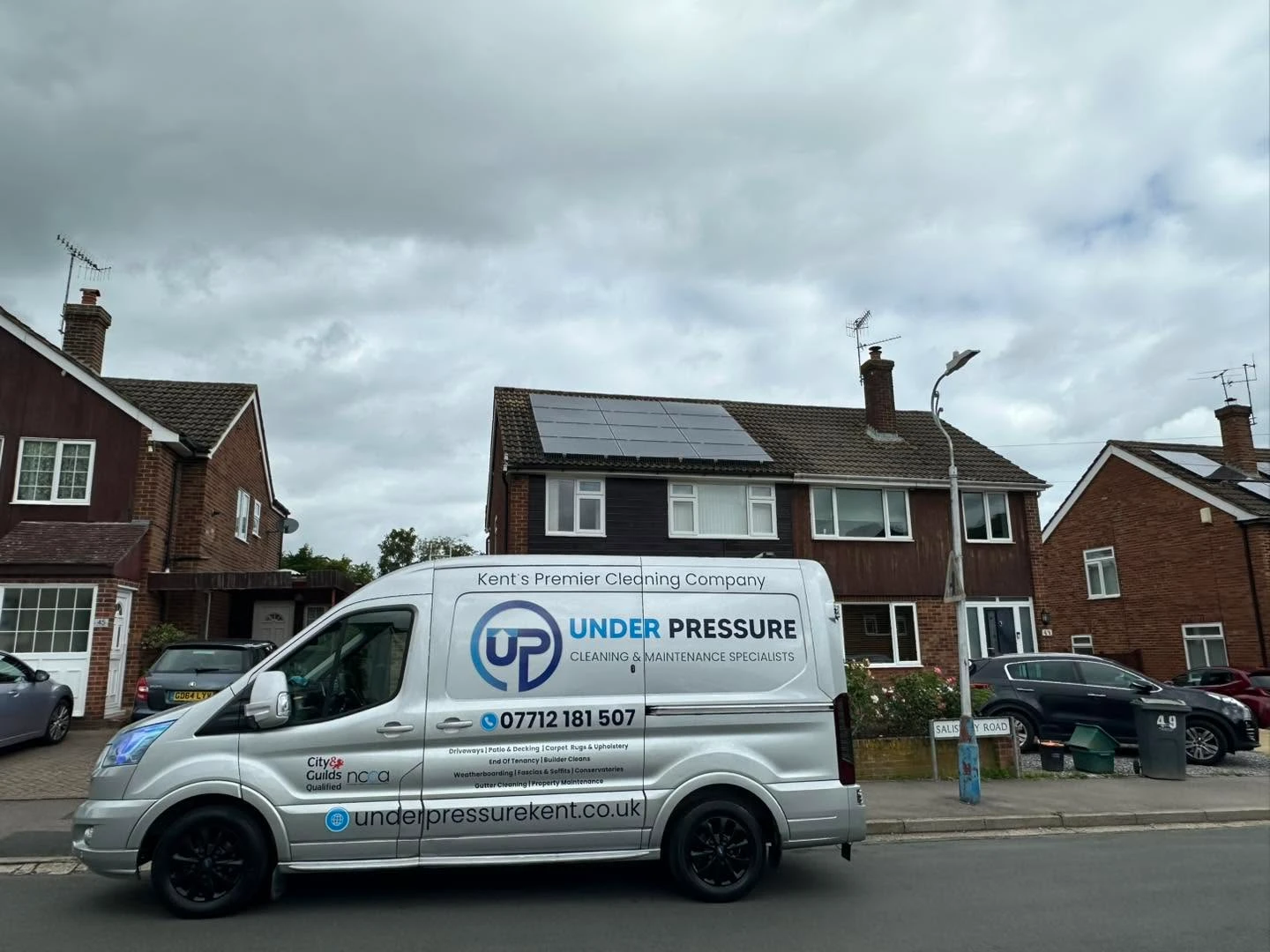 Under Pressure van parked outside a house.