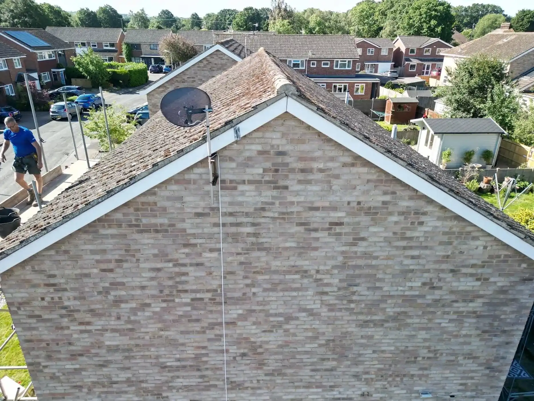 Side of a house being cleaned.